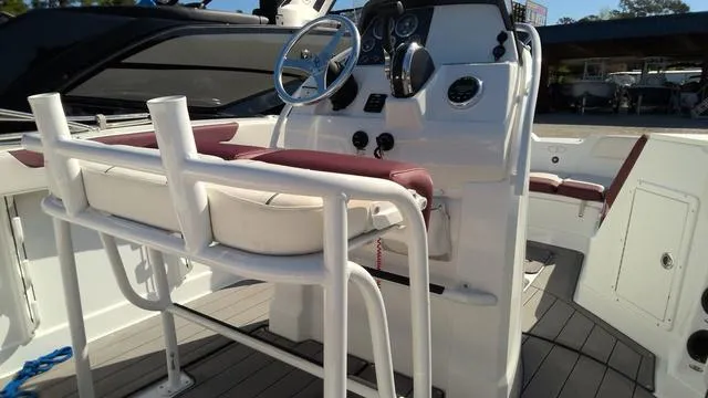 Slide: The Image of 2019 Tahoe 2150 CC boat interior with steering console and seating. - 8