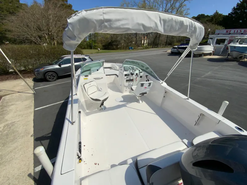 Slide: The Image of 2015 Tidewater 196 DC Explorer boat with canopy, parked in a lot. - 10