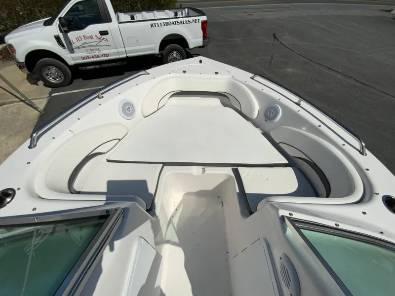 Slide: The Image of 2015 Tidewater 196 DC Explorer boat interior with seating, parked truck in background. - 17