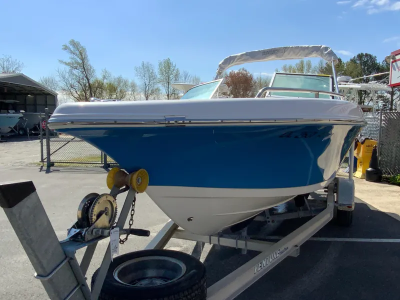 Slide: The Image of 2015 Tidewater 196 DC Explorer boat on trailer, blue hull, parked outdoors. - 4