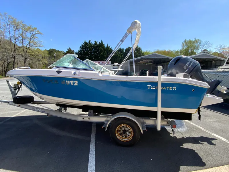 Slide: The Image of 2015 Tidewater 196 DC Explorer boat on trailer in parking lot. - 6