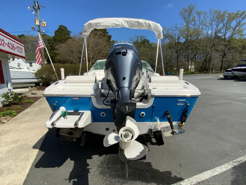Slide: The Image of 2015 Tidewater 196 DC Explorer boat with outboard motor, parked outdoors. - 8