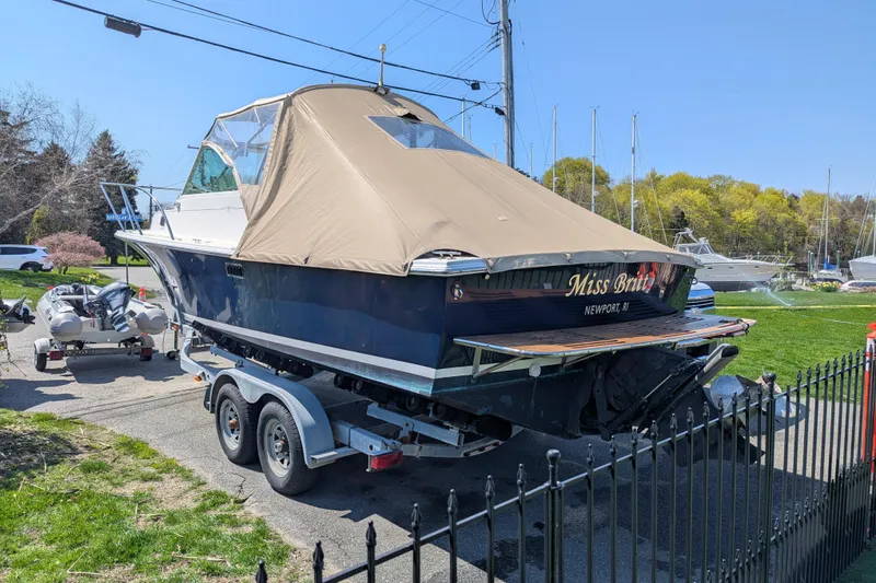 Slide: The Image of 2004 Hunt Yachts Surfhunter 25 on trailer, covered, parked outdoors. - 10