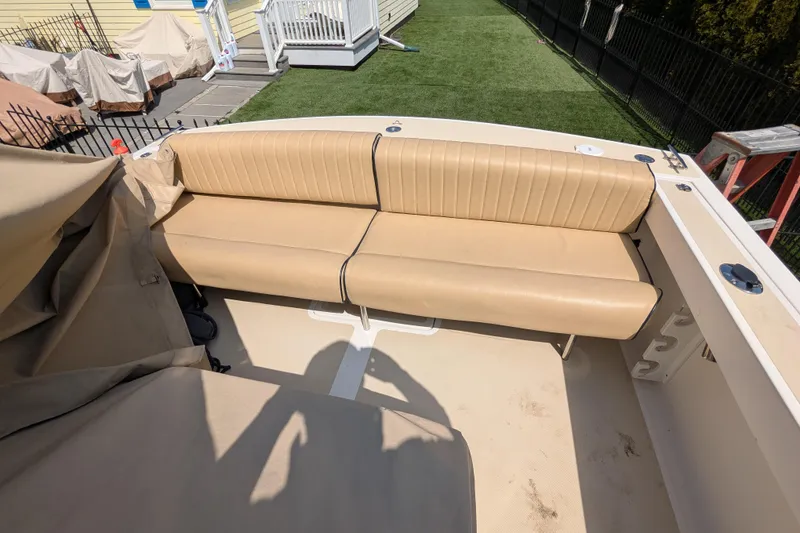 Slide: The Image of 2004 Hunt Yachts Surfhunter 25 with tan seating, outdoor setting. - 21