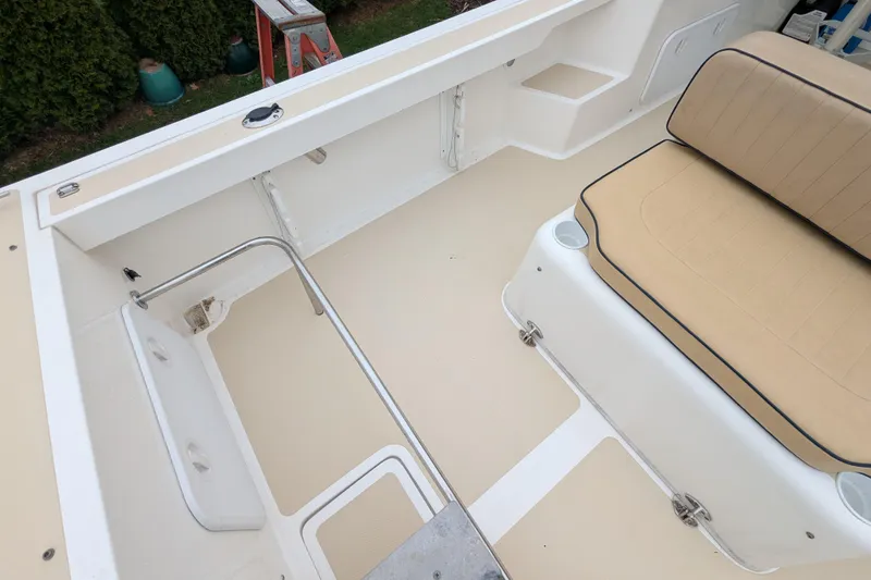 Slide: The Image of 2004 Hunt Yachts Surfhunter 25 interior with beige seating and spacious deck area. - 23