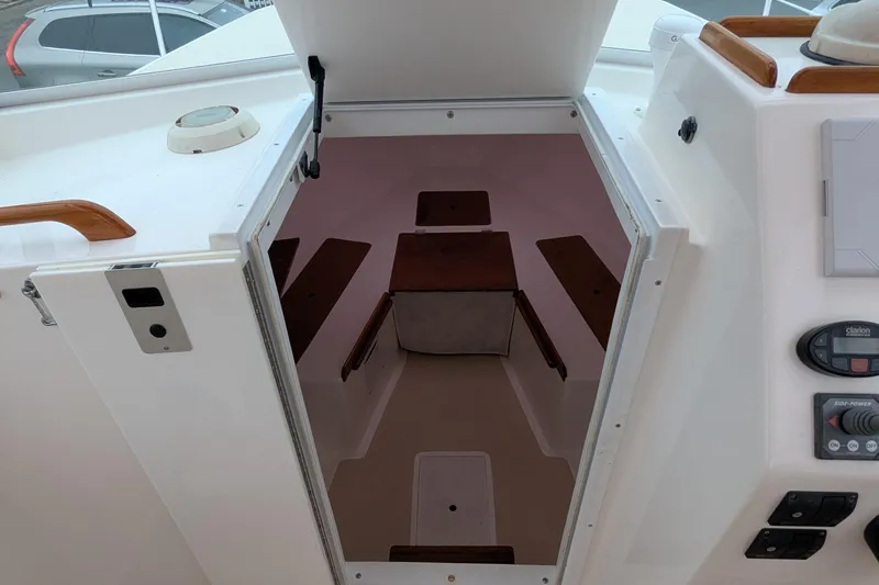 Slide: The Image of 2004 Hunt Yachts Surfhunter 25 cabin interior with wood accents and control panel. - 28