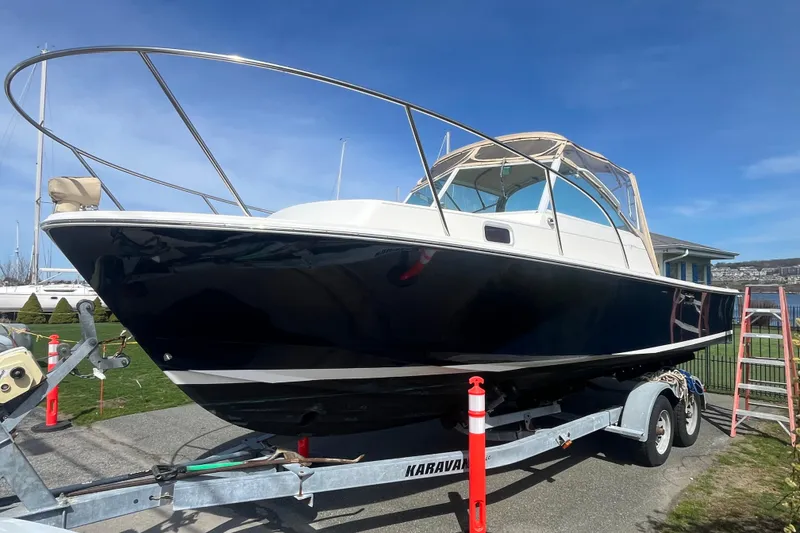 Slide: The Image of 2004 Hunt Yachts Surfhunter 25 on trailer, sleek design, blue hull, sunny day. - 3