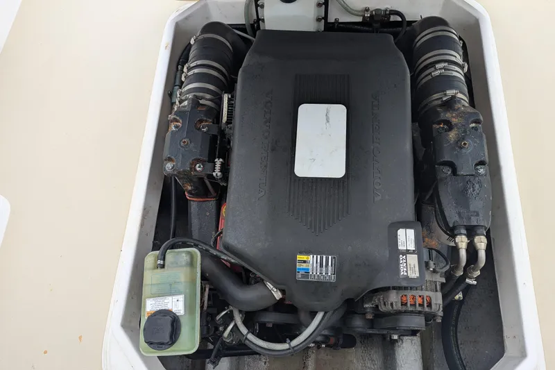 Slide: The Image of Engine compartment of a 2004 Hunt Yachts Surfhunter 25, showcasing mechanical components. - 31