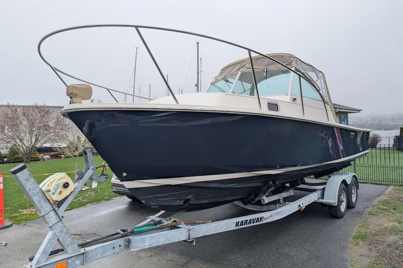 Slide: The Image of 2004 Hunt Yachts Surfhunter 25 on trailer, parked outdoors, with overcast sky. - 5