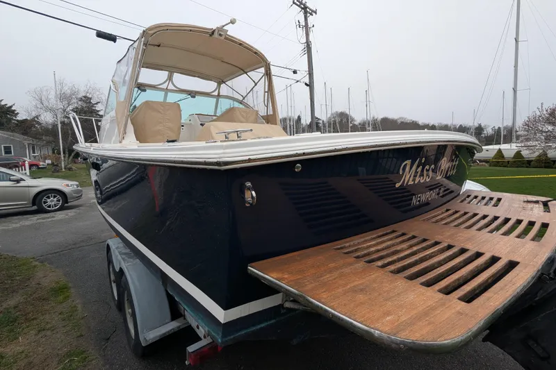 Slide: The Image of 2004 Hunt Yachts Surfhunter 25 on trailer, featuring wooden swim platform. - 8