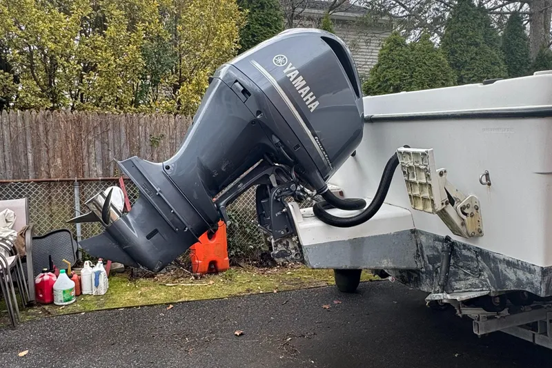 Slide: The Image of 2000 Seaswirl Striper WALKAROUND boat with Yamaha outboard motor in a yard setting. - 13