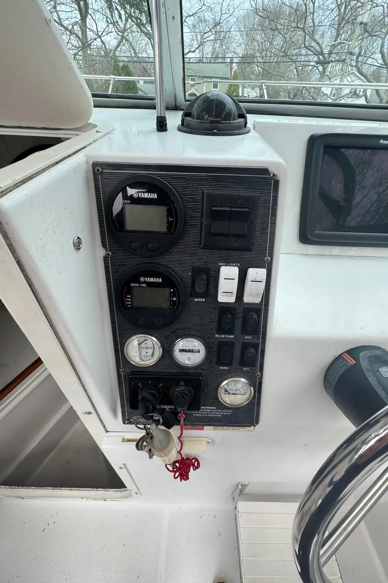 Slide: The Image of Control panel of a 2000 Seaswirl Striper WALKAROUND boat with gauges and switches. - 16