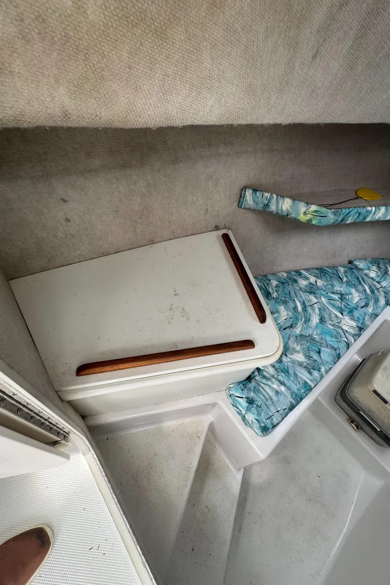 Slide: The Image of Interior of 2000 Seaswirl Striper WALKAROUND boat with seating and storage area. - 17