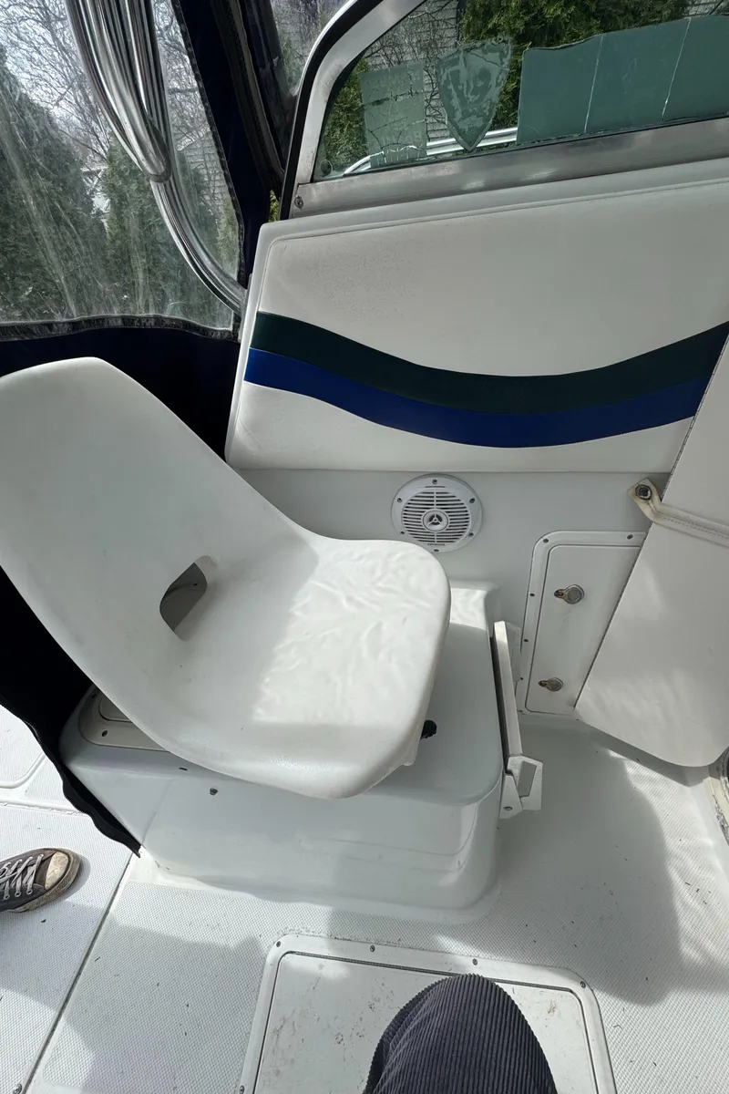 Slide: The Image of 2000 Seaswirl Striper WALKAROUND boat interior with white seating and blue accent. - 18