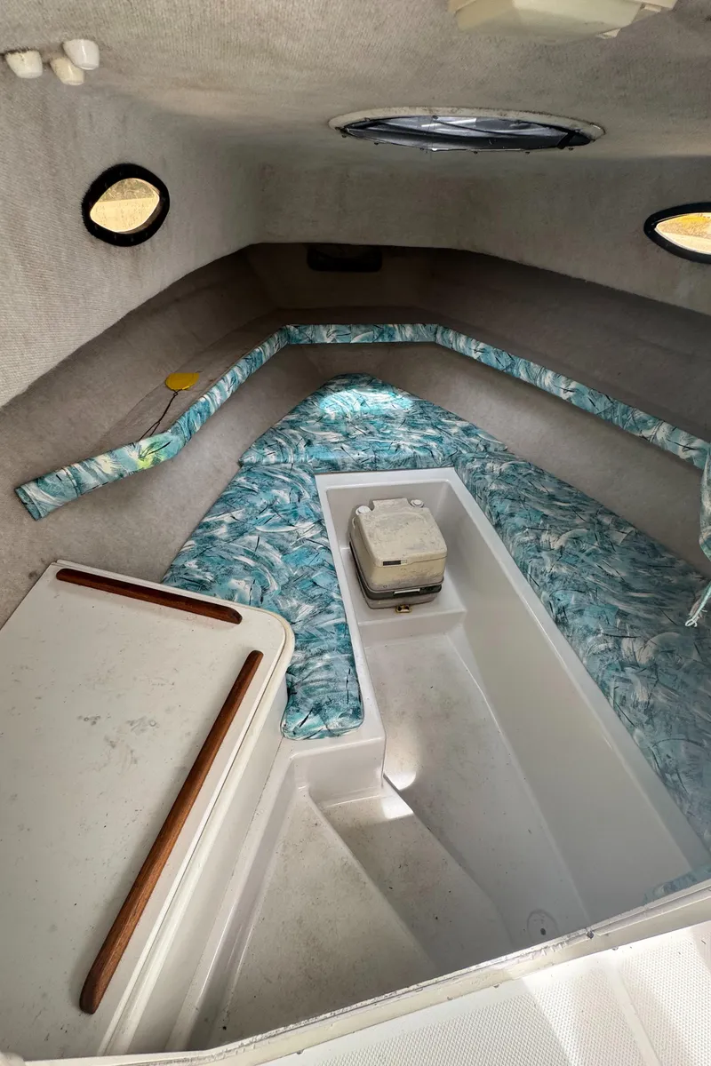 Slide: The Image of 2000 Seaswirl Striper WALKAROUND cabin interior with patterned cushions and compact layout. - 20