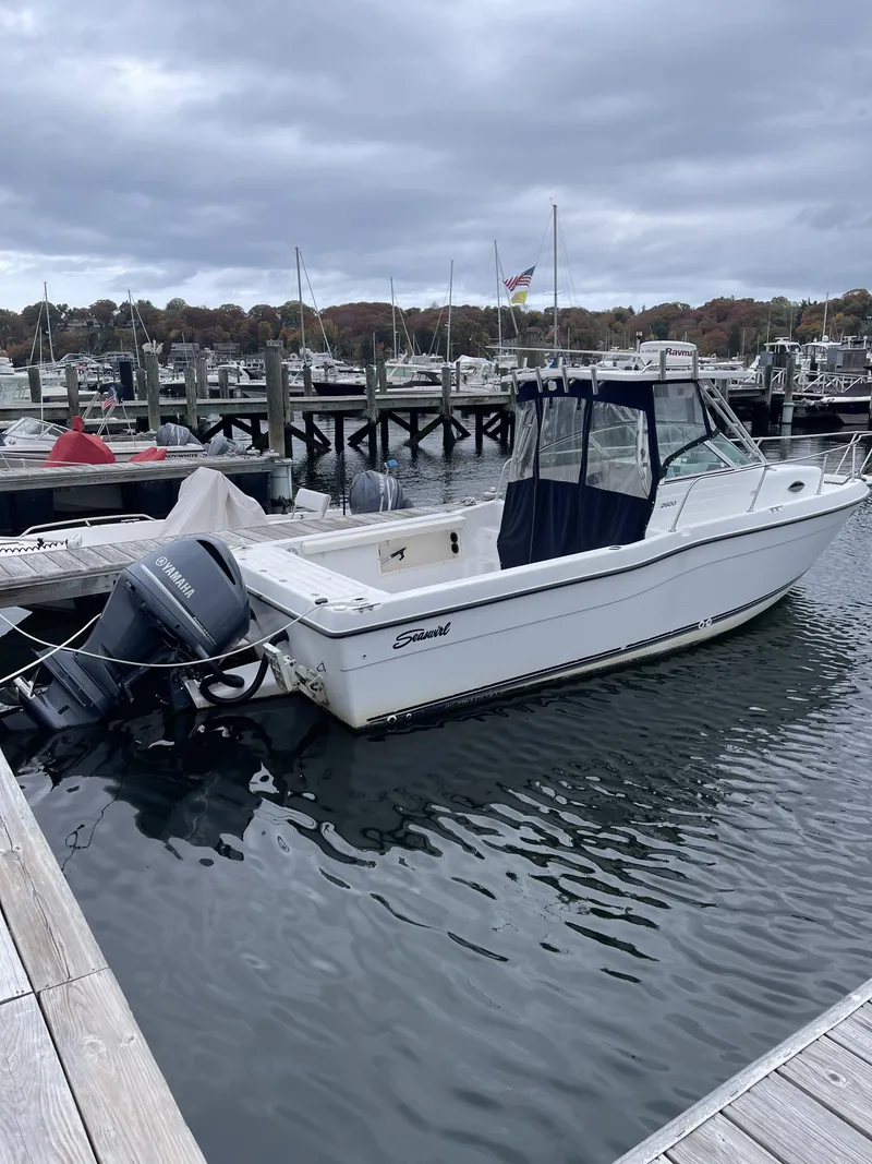 Slide: The Image of 2000 Seaswirl Striper WALKAROUND boat docked at marina under cloudy sky. - 4