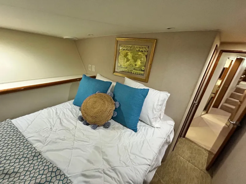 Slide: The Image of Bedroom interior of 2001 Viking 55 Convertible yacht with cozy bed and decorative pillows. - 10