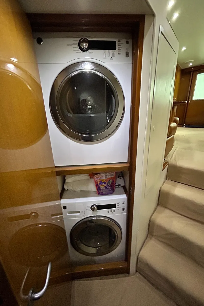 Slide: The Image of Laundry area inside 2001 Viking 55 Convertible yacht with stacked washer and dryer. - 13