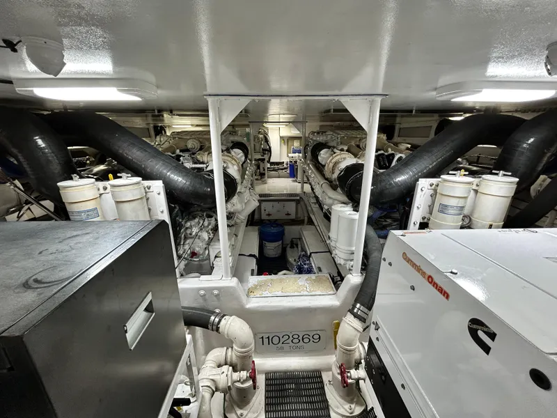 Slide: The Image of Engine room of 2001 Viking 55 Convertible yacht, featuring complex machinery and equipment. - 15