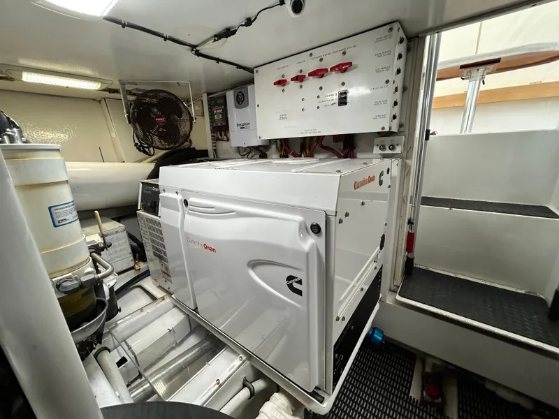 Slide: The Image of Engine room of a 2001 Viking 55 Convertible yacht, featuring a Cummins generator. - 16