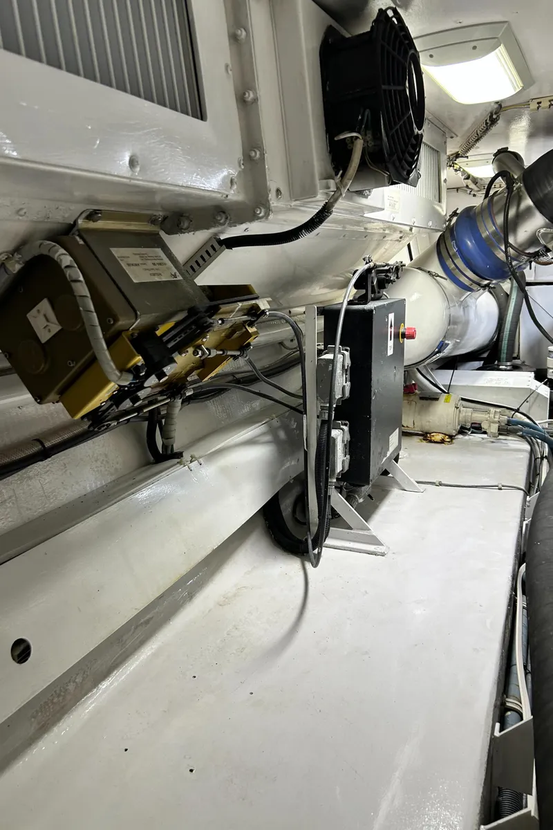Slide: The Image of Engine room of a 2001 Viking 55 Convertible yacht, showcasing mechanical components and wiring. - 18