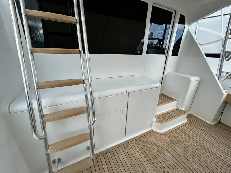 Slide: The Image of 2001 Viking 55 Convertible yacht interior with wooden steps and sleek white cabinetry. - 27