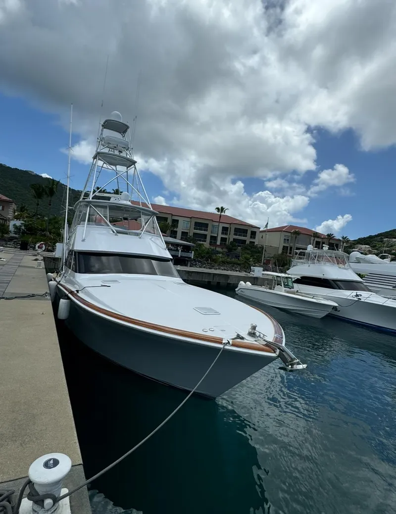 Slide: The Image of 2001 Viking 55 Convertible yacht docked at marina under cloudy sky. - 29