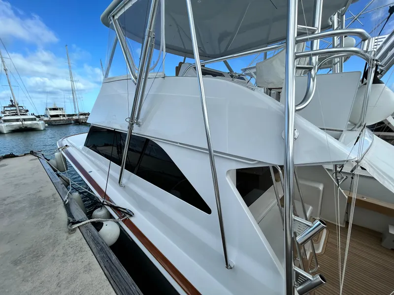 Slide: The Image of 2001 Viking 55 Convertible yacht docked at marina under clear blue sky. - 32