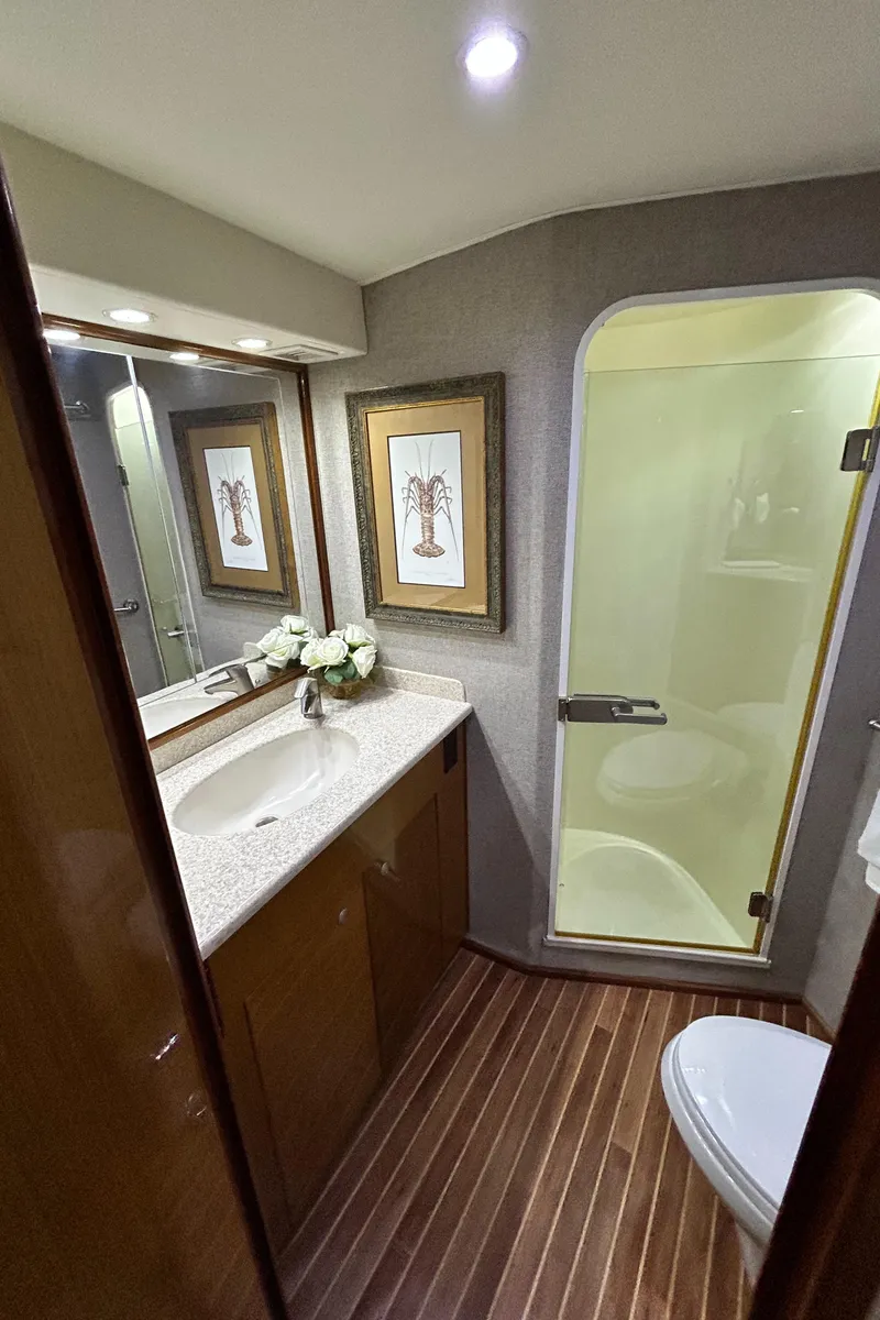 Slide: The Image of Luxurious bathroom in 2001 Viking 55 Convertible yacht with modern fixtures and elegant decor. - 7