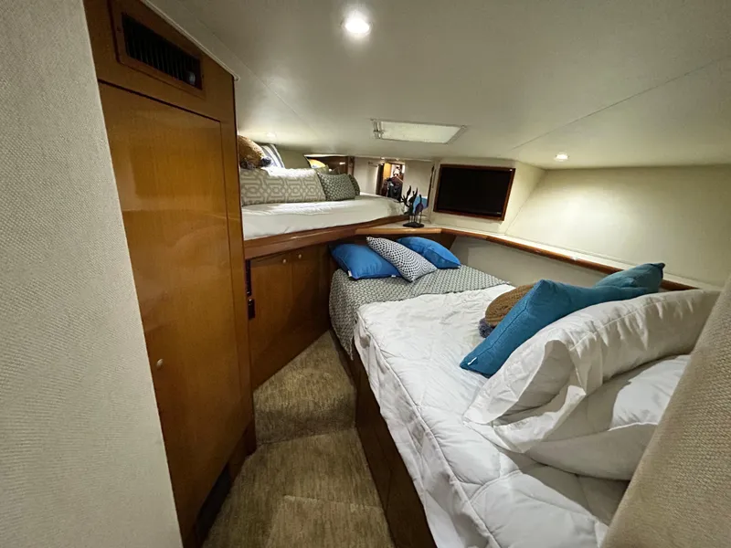Slide: The Image of 2001 Viking 55 Convertible cabin with cozy beds and wooden cabinetry. - 8