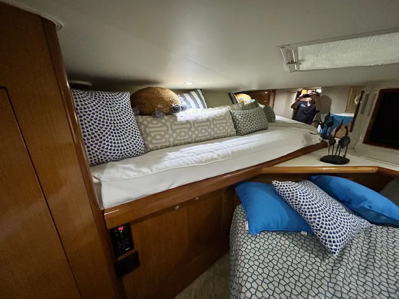 Slide: The Image of Cozy cabin interior of 2001 Viking 55 Convertible yacht with stylish bedding and decor. - 9