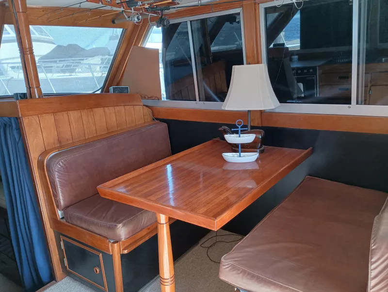 Slide: The Image of Interior of a 1978 Pacific Bluefin SPF boat with wooden table and seating area. - 10