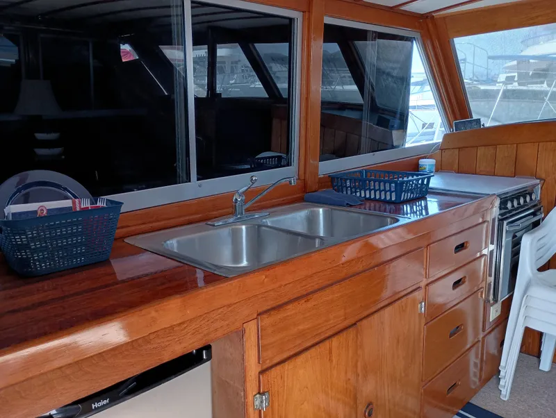 Slide: The Image of Interior of a 1978 Pacific Bluefin SPF boat with wooden cabinetry and stainless steel sink. - 14