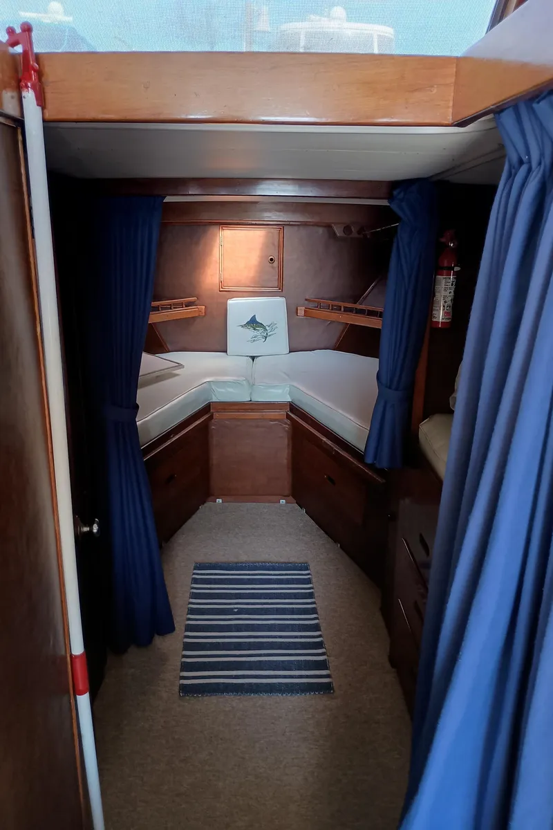 Slide: The Image of Interior of 1978 Pacific Bluefin SPF boat with cozy cabin and blue curtains. - 18