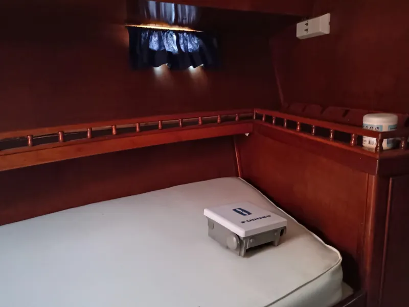 Slide: The Image of Cozy cabin interior of 1978 Pacific Bluefin SPF boat with wooden accents and small window. - 21