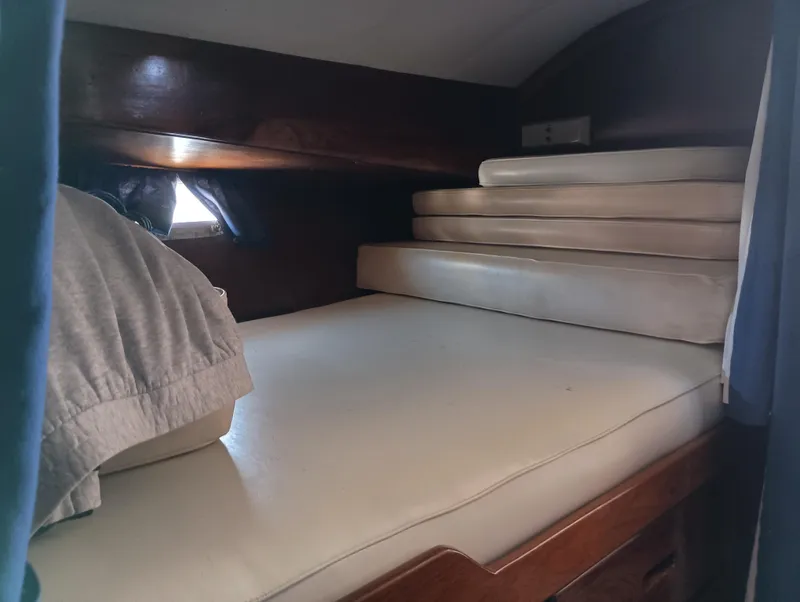 Slide: The Image of Cozy cabin interior of 1978 Pacific Bluefin SPF boat with stacked cushions and bedding. - 25