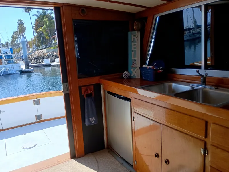 Slide: The Image of Interior of a 1978 Pacific Bluefin SPF boat with wooden cabinetry and dual sink. - 29