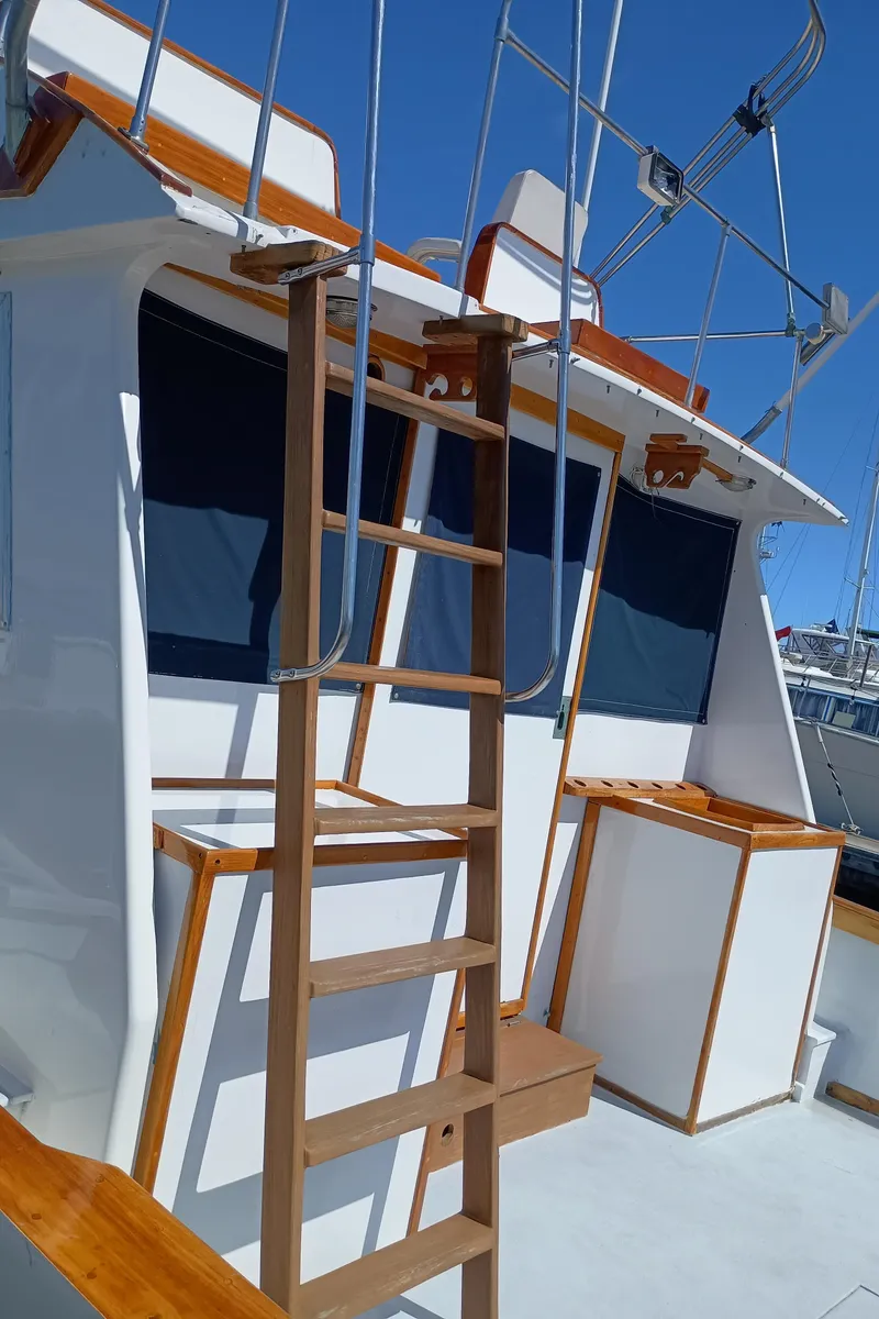 Slide: The Image of 1978 Pacific Bluefin SPF boat with wooden ladder and blue window covers. - 37