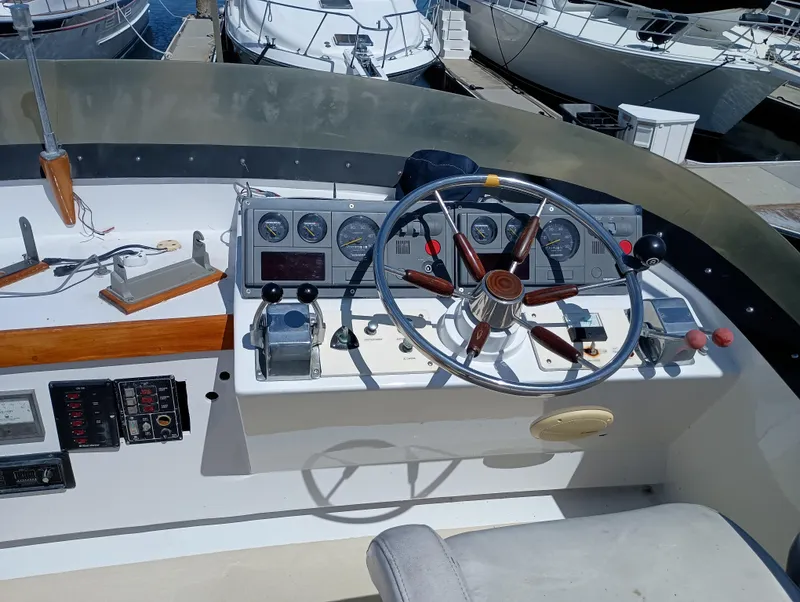 Slide: The Image of 1978 Pacific Bluefin SPF boat dashboard with steering wheel and control panel at marina. - 38