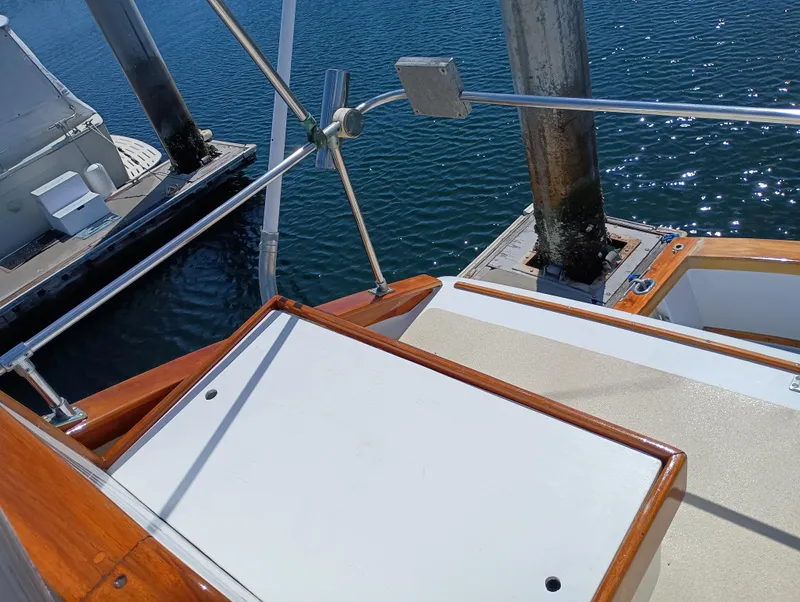 Slide: The Image of 1978 Pacific Bluefin SPF boat deck with wooden trim, docked by calm water. - 40