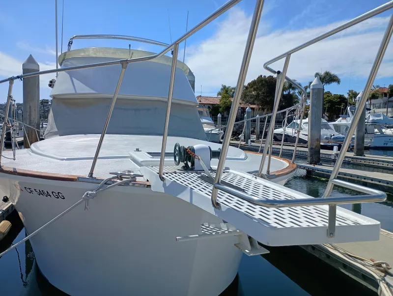 Slide: The Image of 1978 Pacific Bluefin SPF boat docked at marina, featuring a metal gangway. - 46