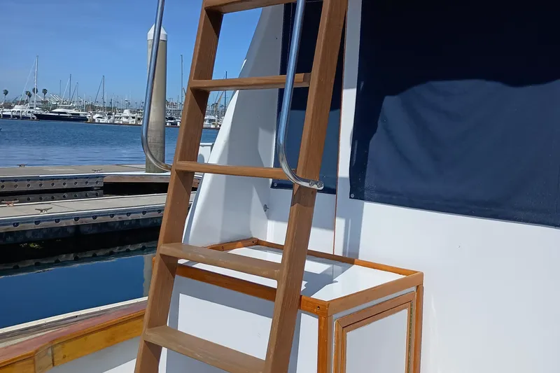 Slide: The Image of Wooden ladder on a 1978 Pacific Bluefin SPF boat docked at a marina. - 5