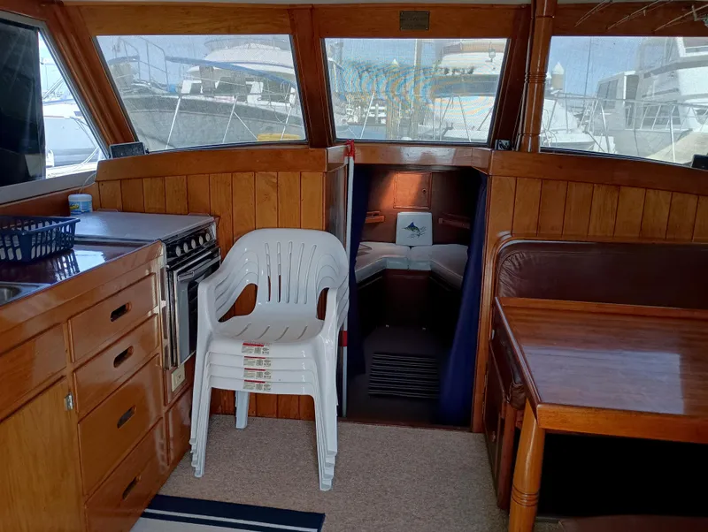 Slide: The Image of Interior of a 1978 Pacific Bluefin SPF boat with wooden furnishings and seating area. - 7
