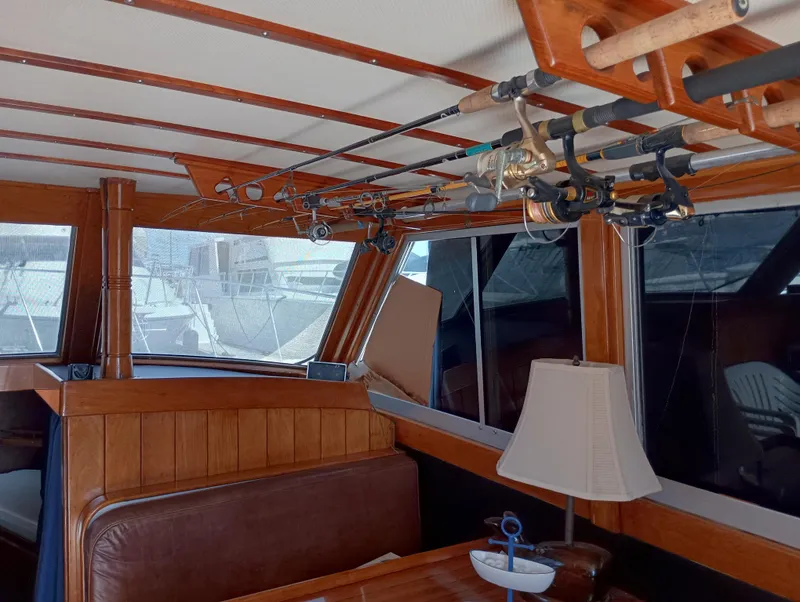 Slide: The Image of Interior of a 1978 Pacific Bluefin SPF boat with fishing rods and wooden furnishings. - 9