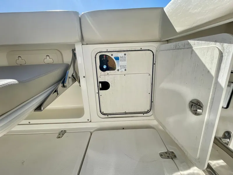 Slide: The Image of 2018 Boston Whaler 315 Conquest interior storage compartment with open hatch. - 21
