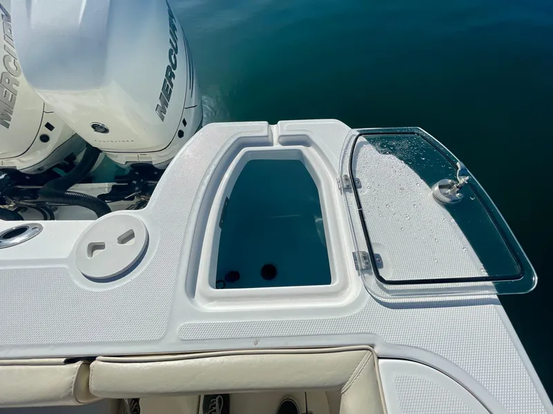 Slide: The Image of 2018 Boston Whaler 315 Conquest boat with open livewell and Mercury engine. - 28