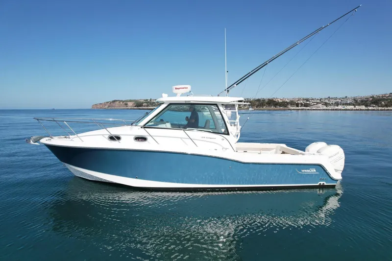 Slide: The Image of 2018 Boston Whaler 315 Conquest boat on calm ocean waters. - 3