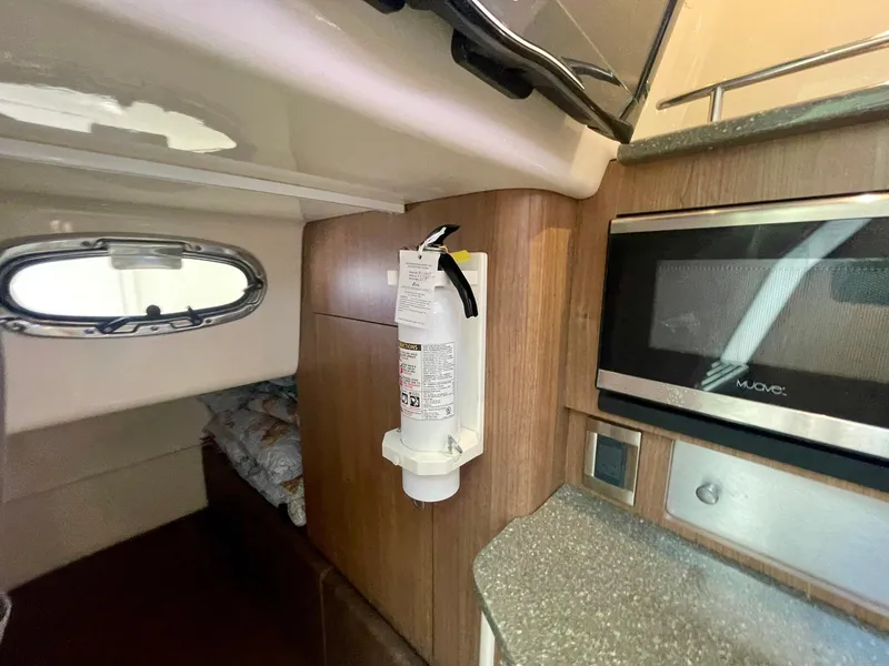Slide: The Image of Interior of 2018 Boston Whaler 315 Conquest with microwave and fire extinguisher. - 38