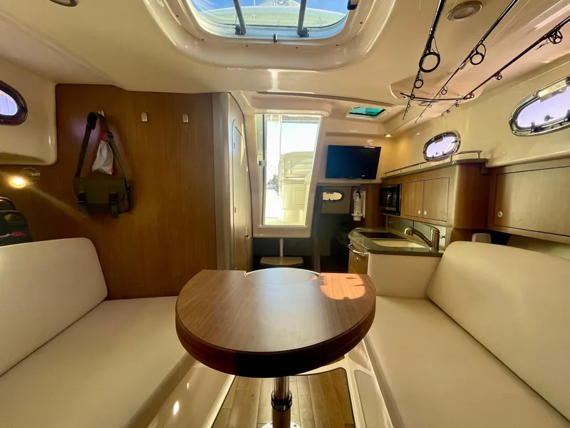 Slide: The Image of Interior of 2018 Boston Whaler 315 Conquest, featuring cozy seating and modern amenities. - 39