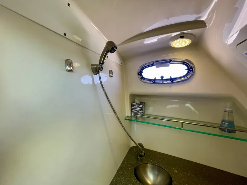 Slide: The Image of 2018 Boston Whaler 315 Conquest bathroom with sink, shower, and porthole window. - 45